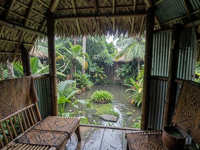 Open-air fale life in Samoa after rain, The inside of a fale looking out at a so