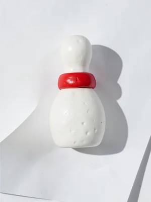 Round chunky clay bowling pin in primary white with stubby cherry-red squat band