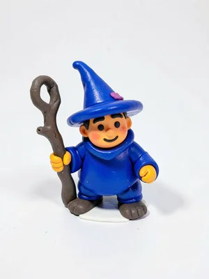 Squat clay wizard miniature in a cobalt-blue robe with an oversized pointy hat a