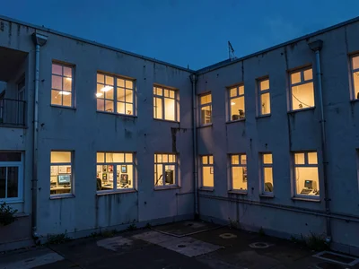 Control room windows glowing warm against cold exterior