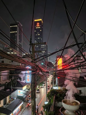 Looking up at Saigon wires and neon