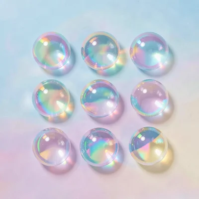Knolling-style flat-lay of nine iridescent marbles arranged in a precise three-b