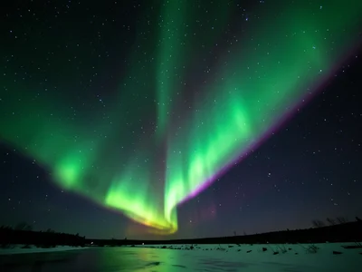 Green aurora curtain draped vertically across sky, sharp lower edge and diffuse 