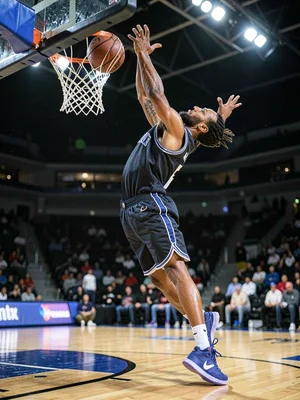 Basketball player dunking from below