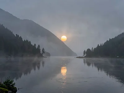 Sun disk visible through moderate mist depth