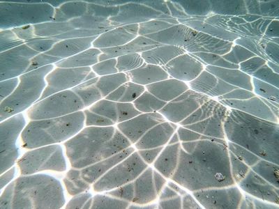 Gentle caustic pattern in still water barely moving