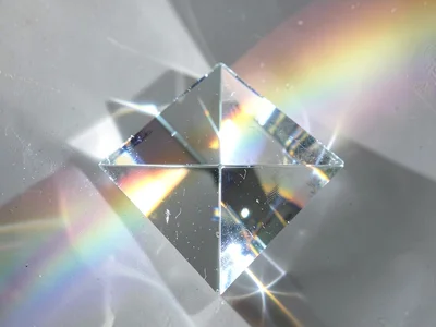 Optical prism splitting white light, rainbow spectrum, physics of glass