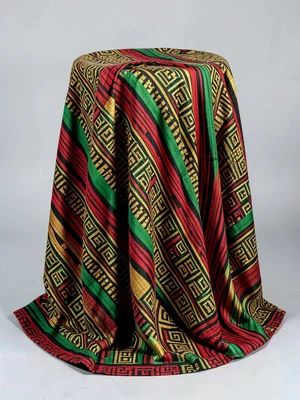 Ceremonial stool covered with draped kente cloth — pattern falling around curved