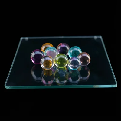 A selection of different colored glass marbles arranged in a loose cluster on th