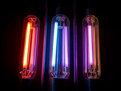 Multiple tubes in different gases: red neon, blue mercury, purple argon, side by