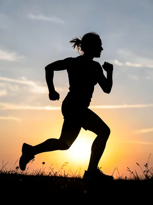 Runner silhouetted against sunrise