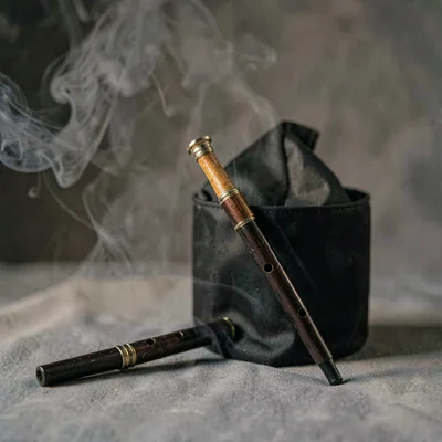 Moody product shot of a manhattan paired with a small flute on a smoky grey swee