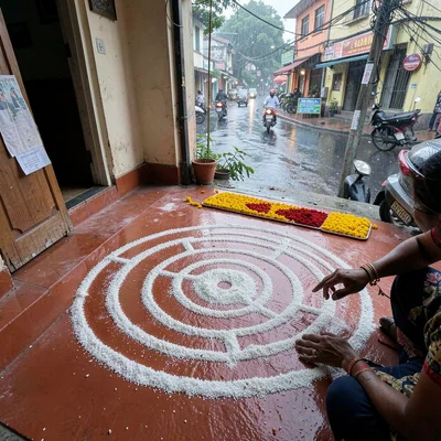 Looking down at Chennai's overlooked patterns, Fresh kolam being drawn at dawn o