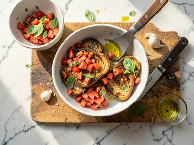 Bruschetta preparation: grilled bread slices, diced tomatoes in a bowl, torn bas