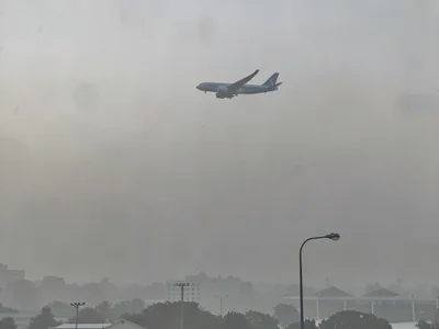 Aircraft visible above smog