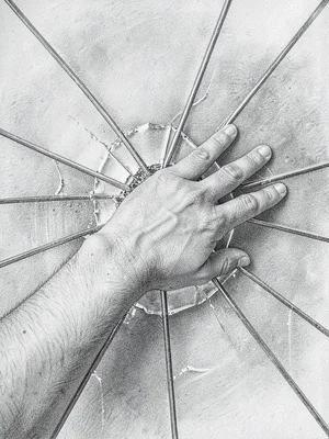 Hand reaching through shattered glass