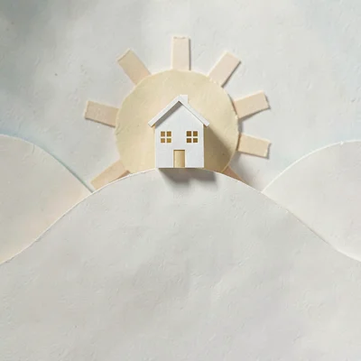 Papercraft empty-state illustration of a small paper-cut house perched on a pape