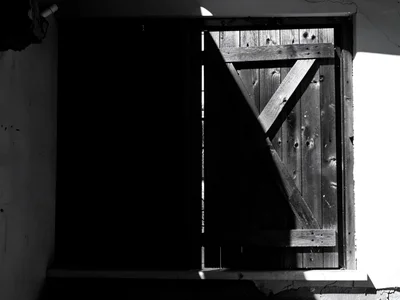Barn door beam cutting through dark