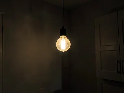Single bare bulb illuminating room