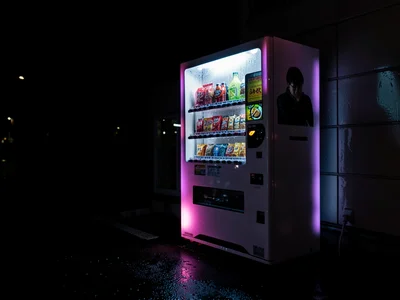 Vending machine reflection showing person behind, the secret watcher in the glas