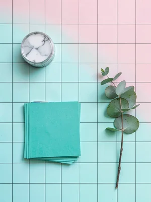 Geometric grid of stationery a marble paperweight a fountain pen, a stack of tea
