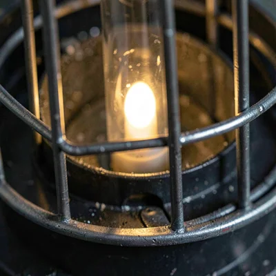 Mineral close-up of a mastering compressor's tube glow inside a metal cage