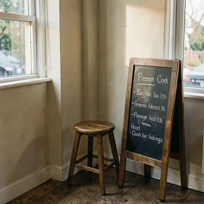 Atmospheric corner pickup with a single stool and a chalkboard menu