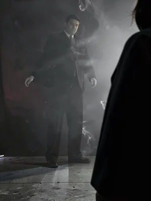 Figure from behind at right edge with half of body cropped