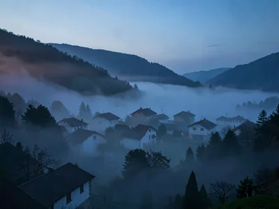 Village emerging from fog with only rooftops visible