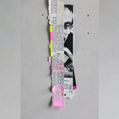 Vertical collage of stacked paper layers with a long ribbon trailing down