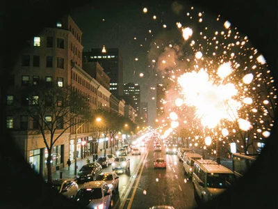 City at night through Holga, every light source blooming into soft explosions, u