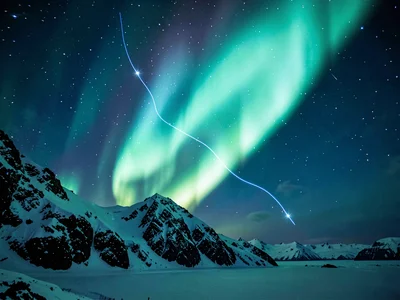 Aurora behind mountain ridge creating glow effect