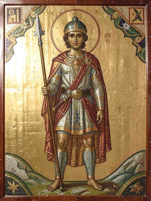 Warrior standing with spear upright, lavish mosaic tesserae clothing