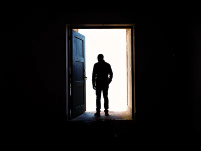 Figure against bright doorway