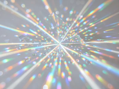 Dense cluster of rainbow caustic reflections from a chandelier crystal on a whit