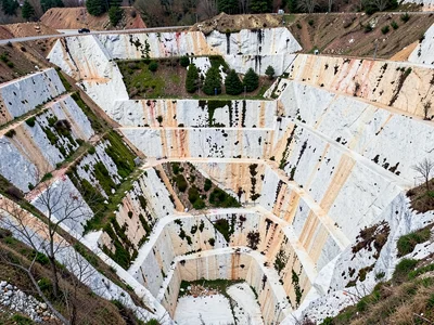 Weathered quarry face showing moss in protected areas