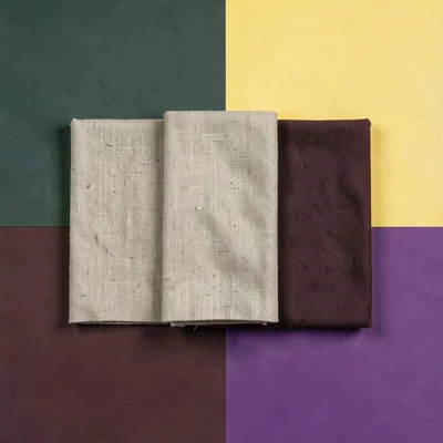 Blockcolor range hero of three linen pieces folded as flat planes, oat and oxblo