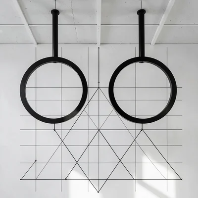 Gymnasium rings hanging from ceiling — two circles suspended in geometric balanc
