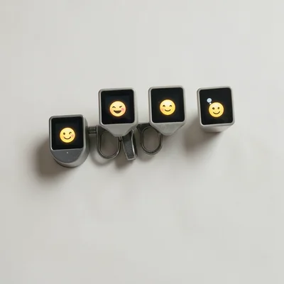 Typewriter keys each containing tiny LED screen with different emoji