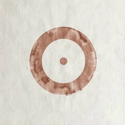 Screenprinted poster of a soft circular brand mark in dusty terracotta on cream