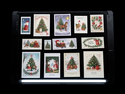 Scanner capture of Christmas card collection, varied designs, holiday tradition