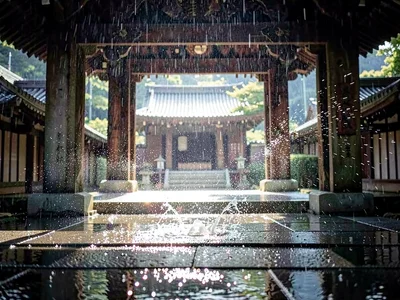 Rain through temple gateway catching light