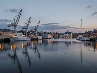 Comfortable grey harbor light in Gothenburg, Sweden, harbor cranes reflected in 