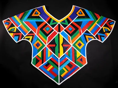 Beaded shoulder cape spread flat — symmetrical geometric wings, studio light