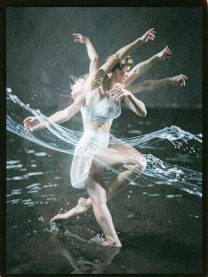 A dancer's body in motion, double-exposed with flowing water, the movement of bo