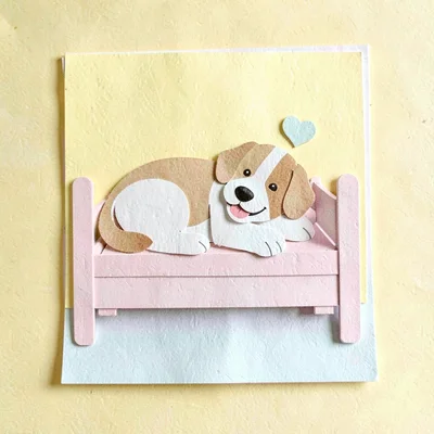 Cut-paper collage of a happy dog napping on a cute wooden bed, sunny yellow back