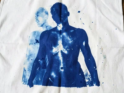 A torso impression pressed onto large fabric sheet — abstract form in Prussian b