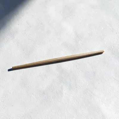 Single chopstick shadow at noon, the presence that creates absence