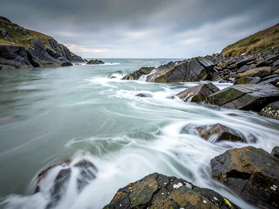 Rocky coastline with milk-white water flowing around