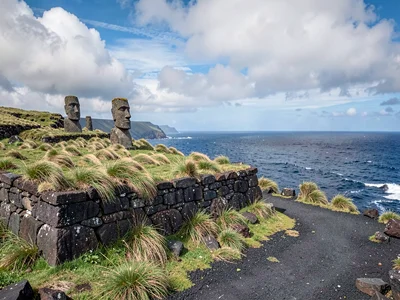 Edge-of-world isolation on Rapa Nui, Ancient stone foundation walls half-buried 